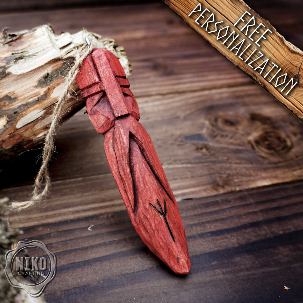 Red wooden viking pendant on a wooden background with 'Niko Crafting' branding.